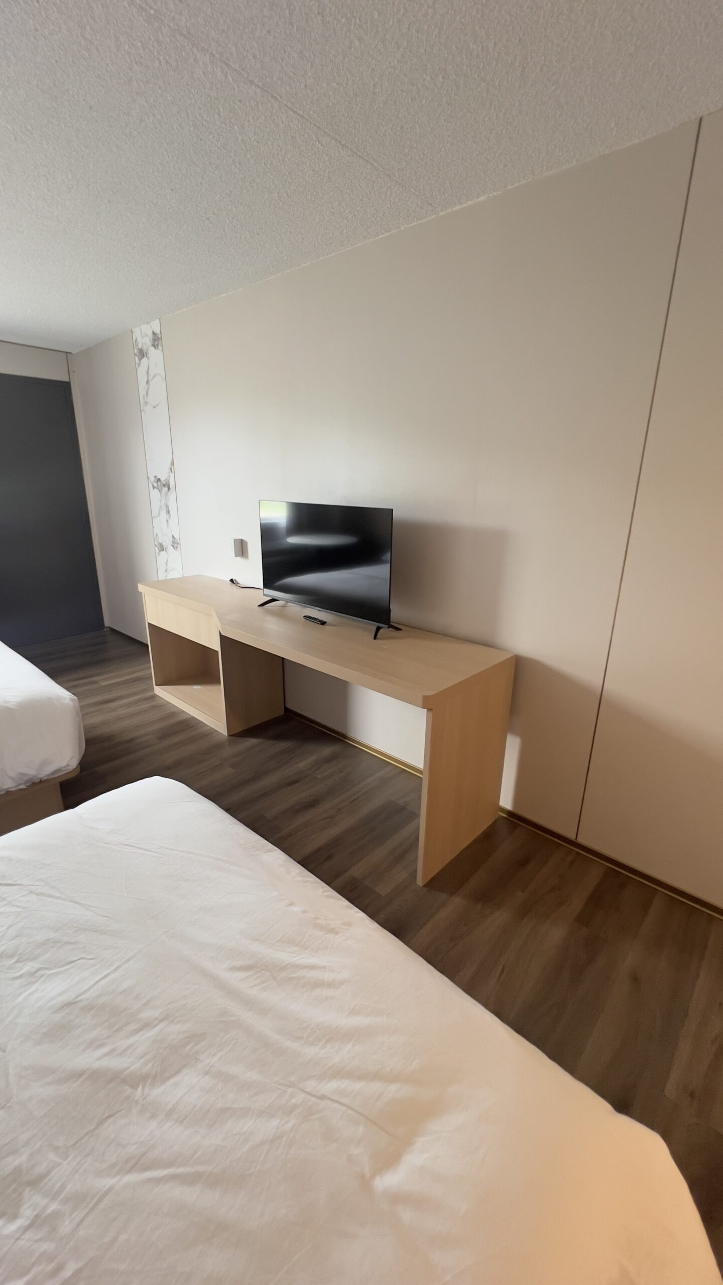 Guest room with fitted desk, storage and flooring