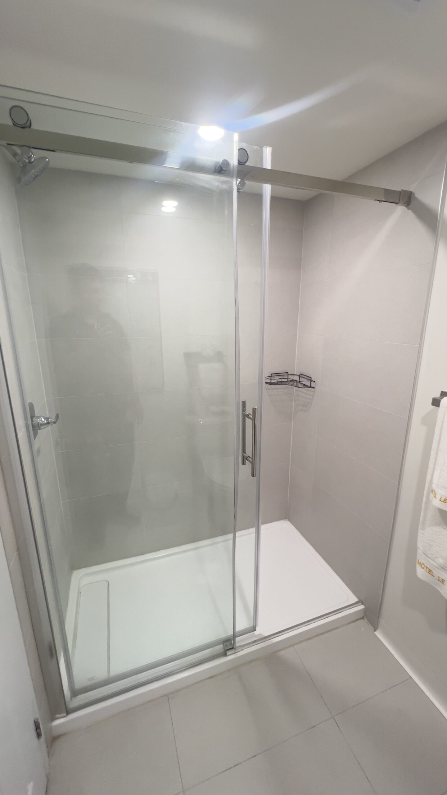 Glass shower in a renovated motel bathroom